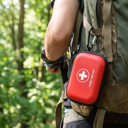 Tactical First Aid Kit clipped to a hiking backpack by its carabiner